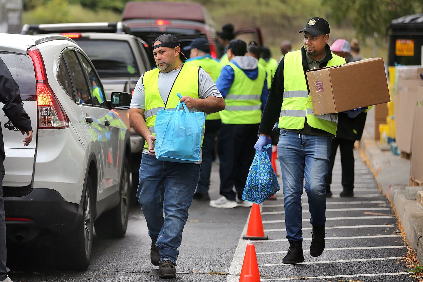 Hundreds of people lined up in their vehicles on Sept. 21 in Pawtucket, R.I., some waiting in line for more than two hours to get food and household items during a "share market" organized by the Elisha Project, a Pawtucket-based nonprofit.