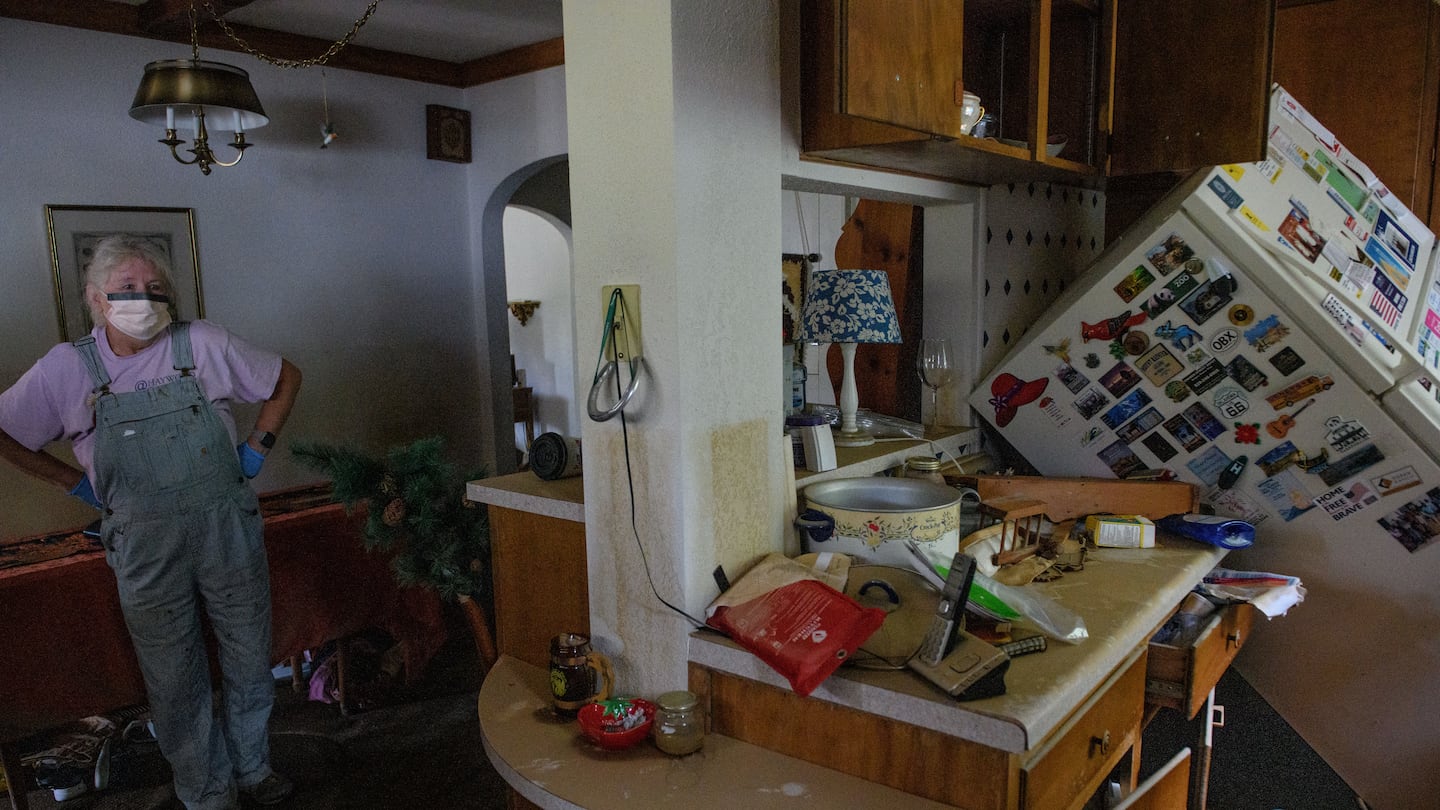 Sharon Hinshaw stood in her long-time friend's kitchen while working to assist in removing damaged belongings on Friday in Camden, North Carolina. According to reports, at least 220 people have been killed across the southeastern US, and more than a million are without power due to the storm.