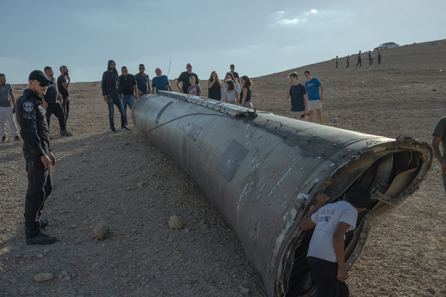 A child peered inside the remains of a missile on Oct. 2, near the Dead Sea, Israel.