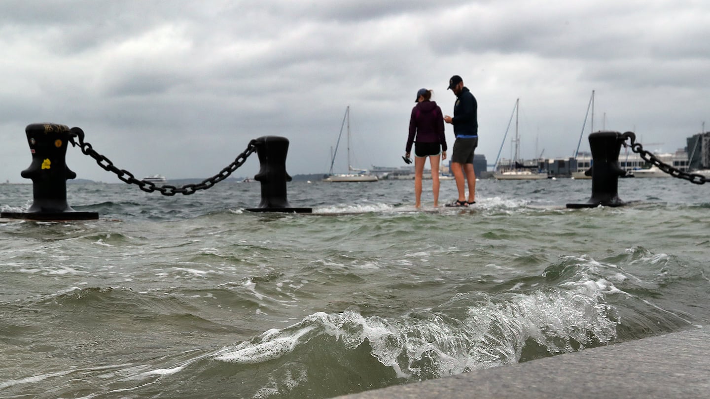 A very high tide, known as a king tide, flooded sections of Long Wharf in Boston in September. The city is working to build dozens of flood protection projects as sea levels rise, increasing the risk of floods during storms.