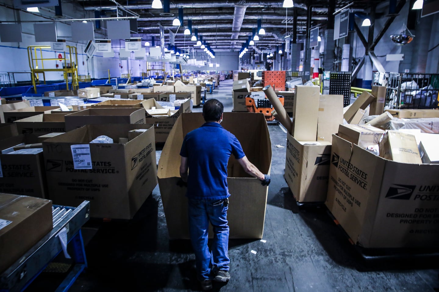 A US Postal Service employee worked on the floor of Fort Point United States Postal Service processing facility in 2021.