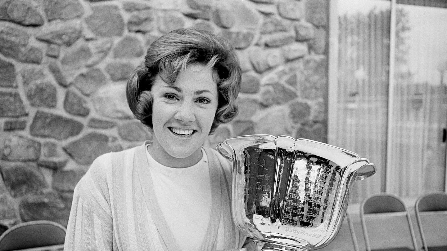 Susie Maxwell held the silver trophy after winning the 36th annual Women's Western golf tournament, June 14, 1965, in Chicago.