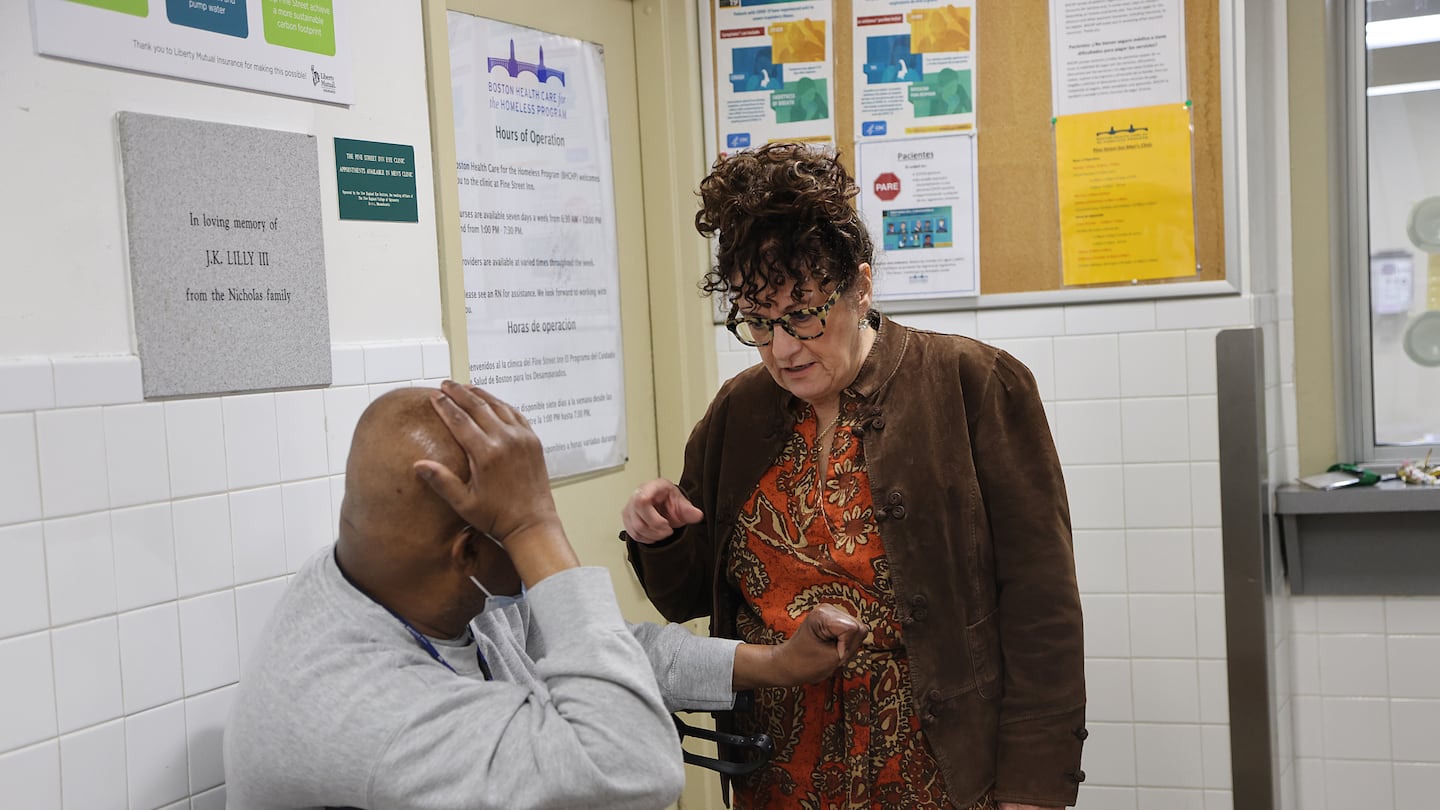 Lyndia Downie, president and executive director of the Pine Street Inn, is celebrating 40 years in her job this year. She spoke to resident Ernest Joseph in the lobby.