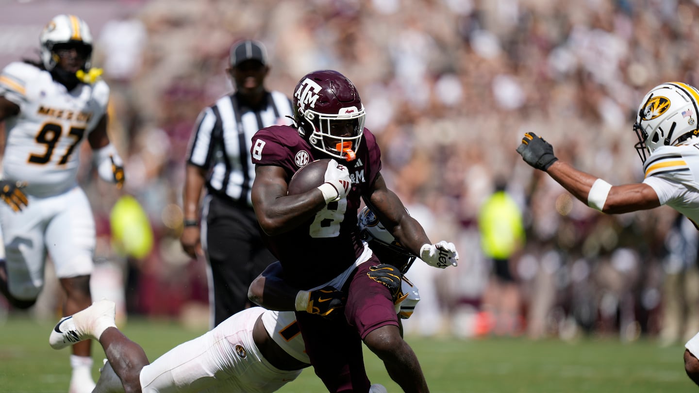 Texas A&M running back Le'Veon Moss rumbles for some of his career-high 138 yards against Triston Newson and the Missouri defense as the No. 25 Aggies rolled to victory Saturday in College Station, Texas.