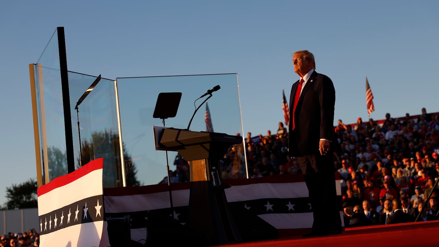 Former president Donald Trump addressed a campaign rally from behind bullet resistant glass at the Butler Farm Show fairgrounds on Saturday.