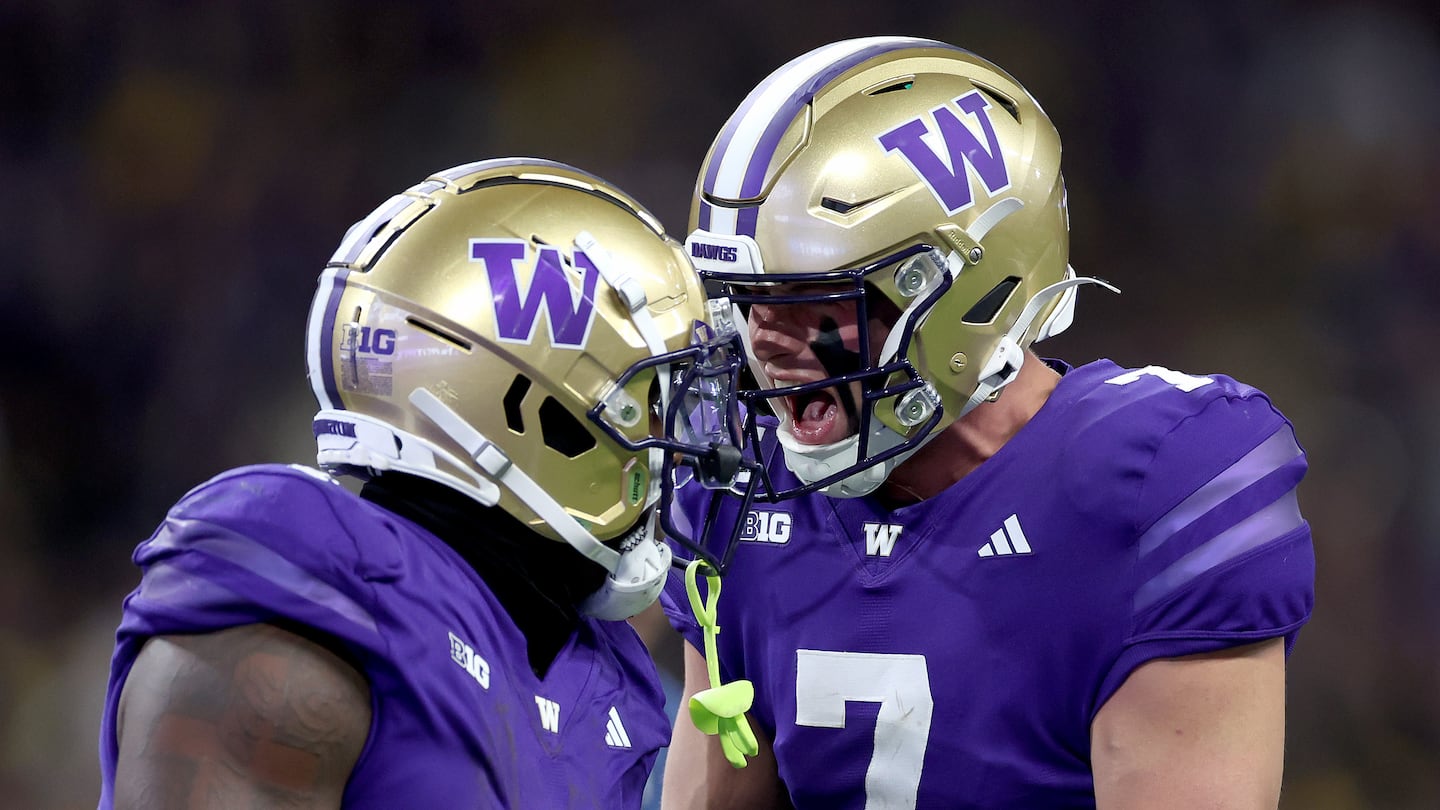 Running back Jonah Coleman (left) and Washington quarterback Will Rogers had a lot to celebrate as the Huskies upset No. 10 Michigan Saturday Seattle.