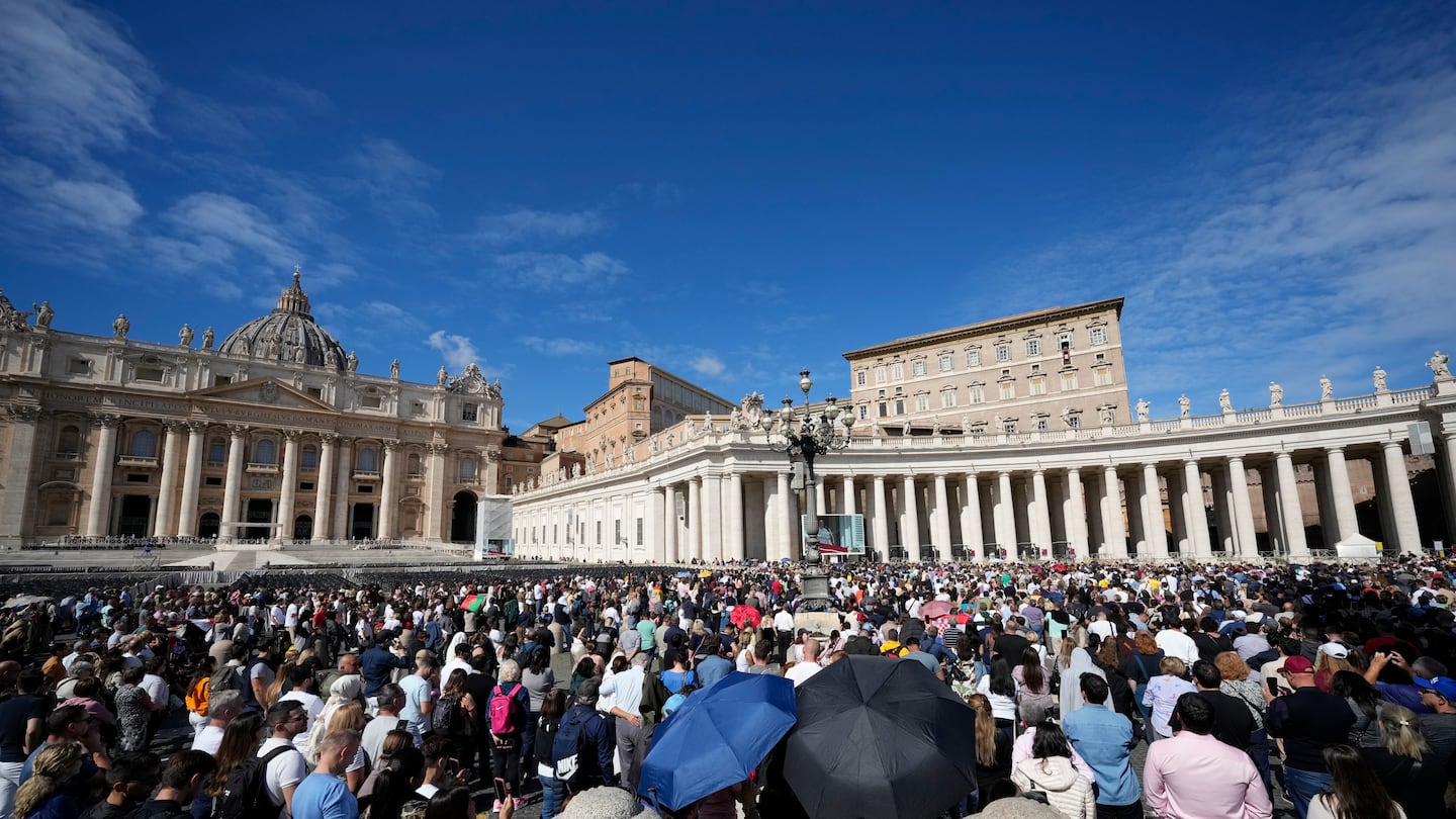 Pope Francis appears at his studio window for the traditional noon blessing of faithful and pilgrims gathered in St. Peter's Square at The Vatican, on Oct. 6.