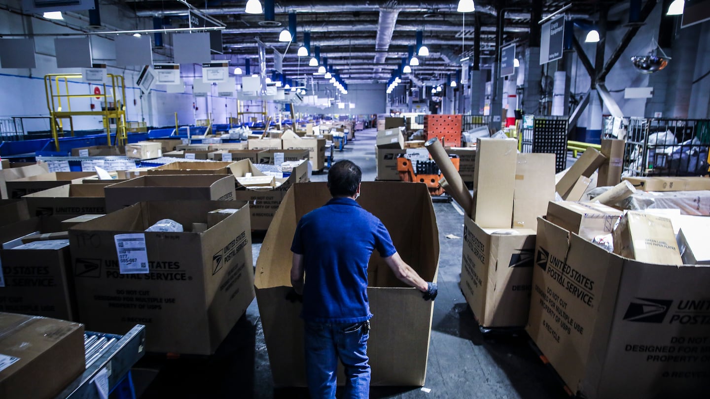 A US Postal Service employee worked on the floor of Fort Point United States Postal Service processing facility in 2021.