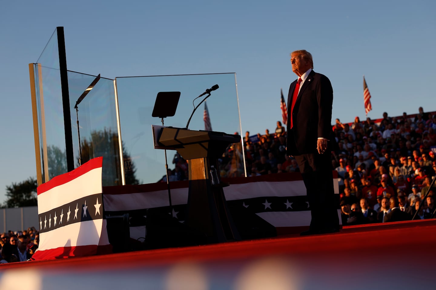 Former president Donald Trump addressed a campaign rally from behind bullet resistant glass at the Butler Farm Show fairgrounds on Saturday.