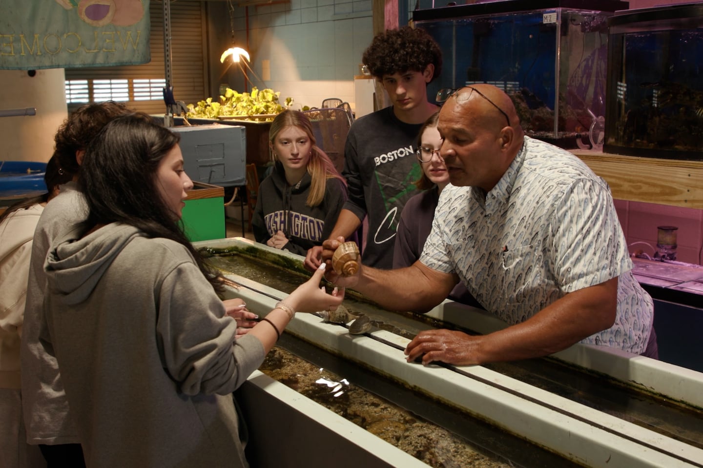 Leonard Baker examined a crustacean while teaching aquaculture, the science of plants and animals in water, at Cranston High School West in Cranston, R.I.