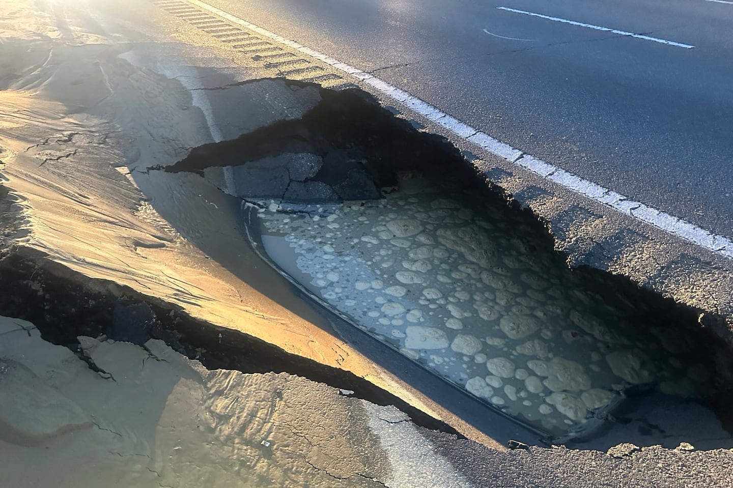 A large sinkhole on I-495 South just after Exit 106 was the result of a water main break, according to State Police.