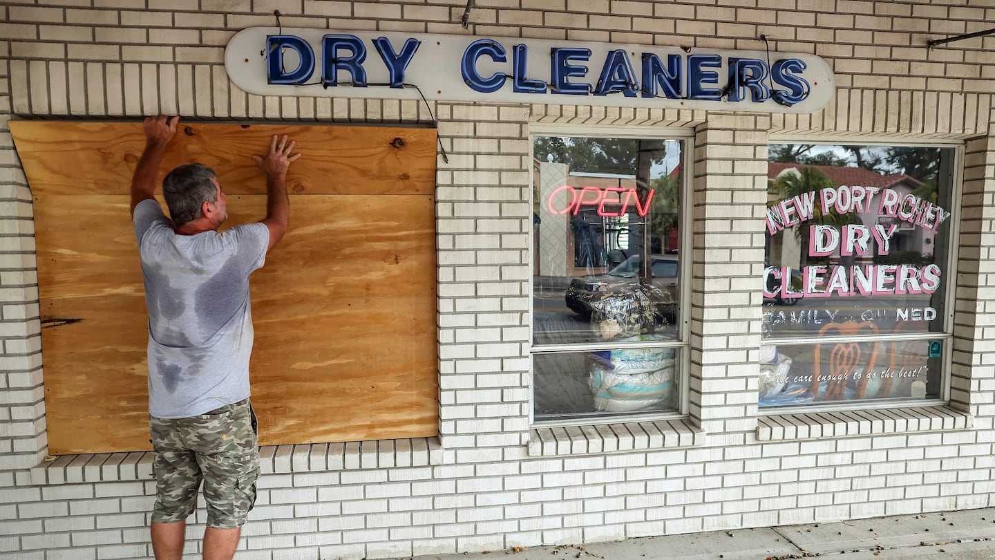 Jay McCoy puts up plywood in preparation for Hurricane Milton, Oct. 7, in New Port Richey, Fla.