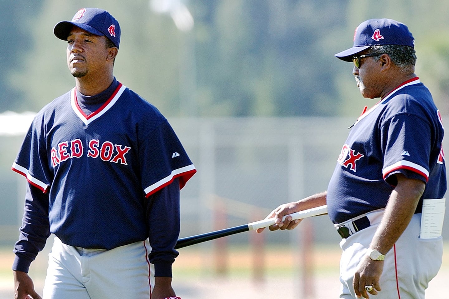 Luis Tiant (right) jokes with Pedro Martinez during spring training in Fort Myers, Florida, in February 2002. Tiant died Tuesday at the age of 83.