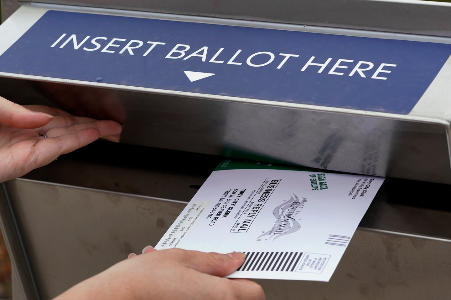 A Michigan voter inserted her absentee voter ballot into a drop box in Troy, Mich. in 2020. 