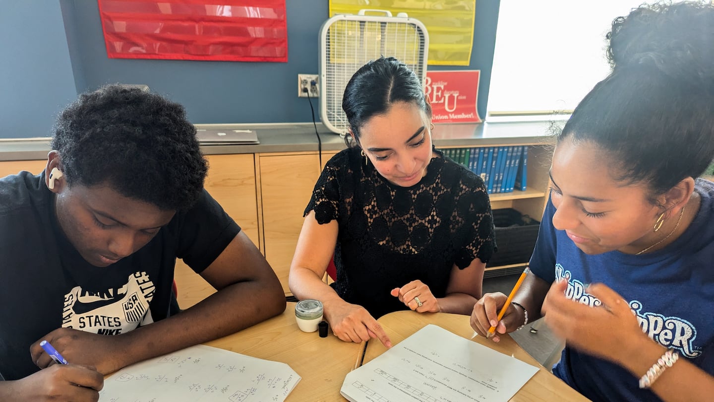 Lisa Rodriguez, who teaches Algebra II and Pre-Calculus Honors and is co-director of the Calculus Project at Brookline High, photographed with students. She said the program has enabled the school to create a team of math teachers, counselors, and volunteers who students can rely on for support.