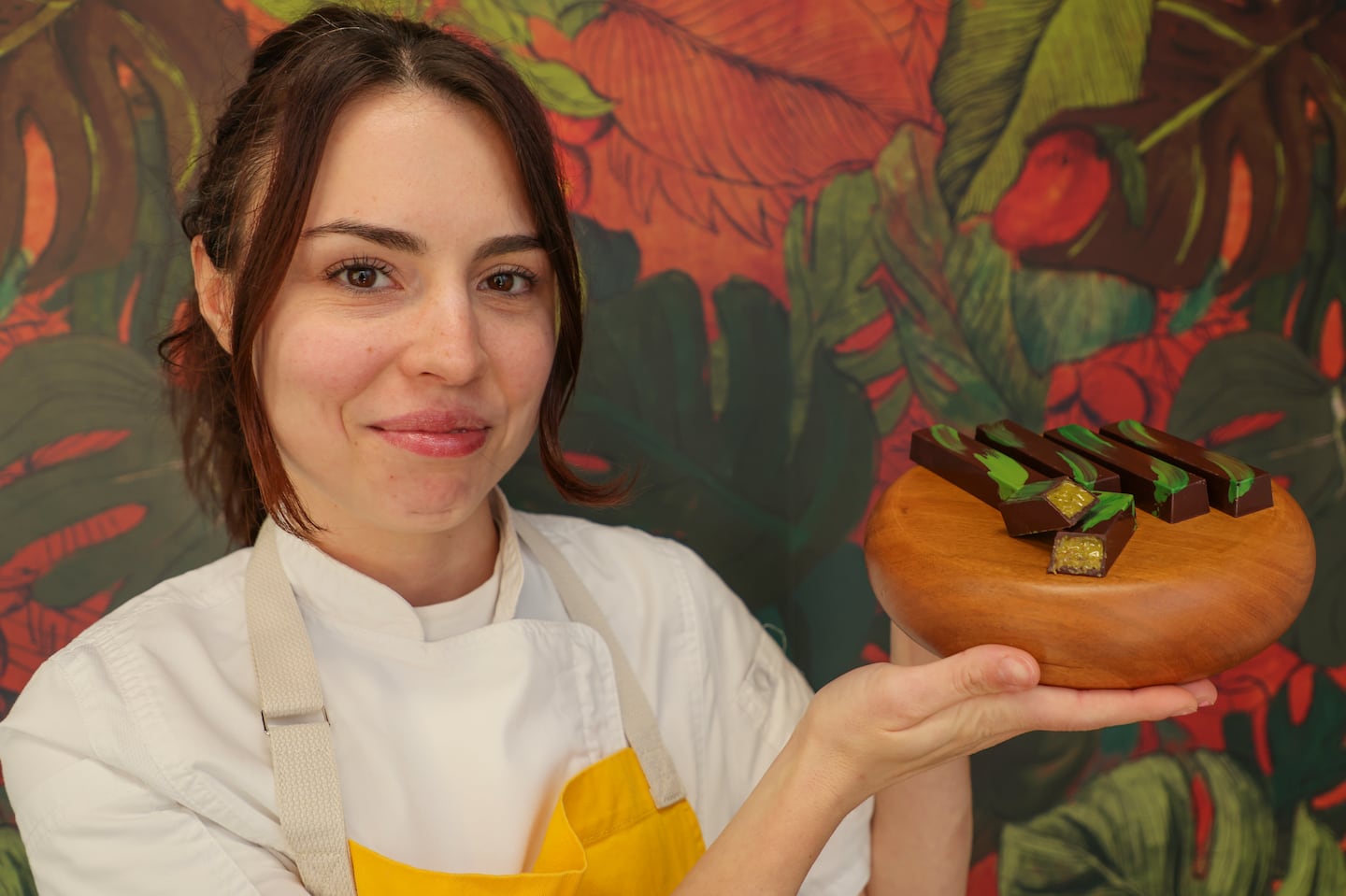 Betty Petrova, owner of Petrova Chocolates in East Boston, displays her handmade version of the viral Dubai chocolate bar.