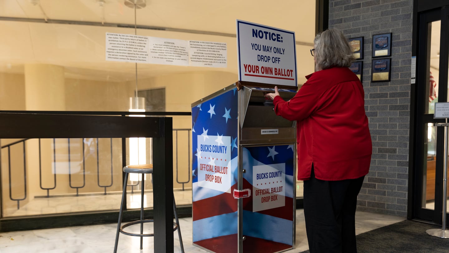 Earlene Austin, 75, drops off a mail-in ballot in Doylestown, Pa., on Oct. 17, 2022.