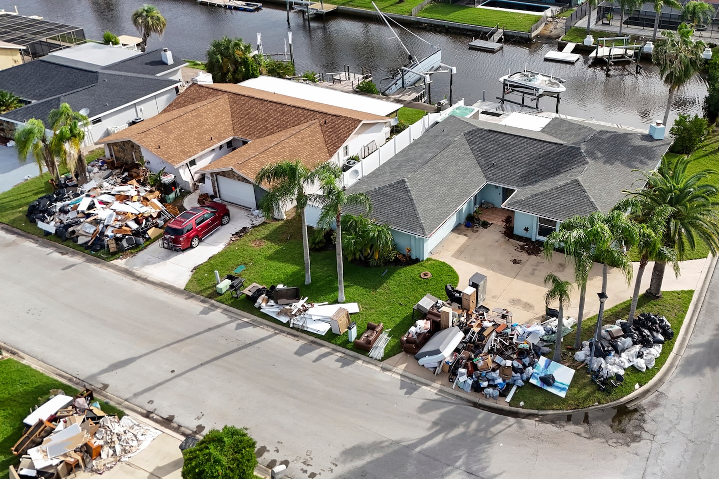 Debris from homes flooded in Hurricane Helene was piled curbside as Hurricane Milton approached on Oct. 8, in Port Richey, Fla.