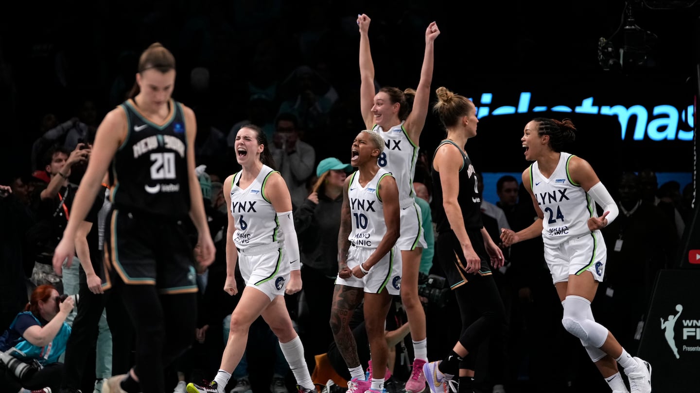 From left, Minnesota Lynx's Bridget Carleton, Courtney Williams, Alanna Smith and Napheesa Collier celebrate after defeating the New York Liberty in overtime in Game 1 of a WNBA Finals.