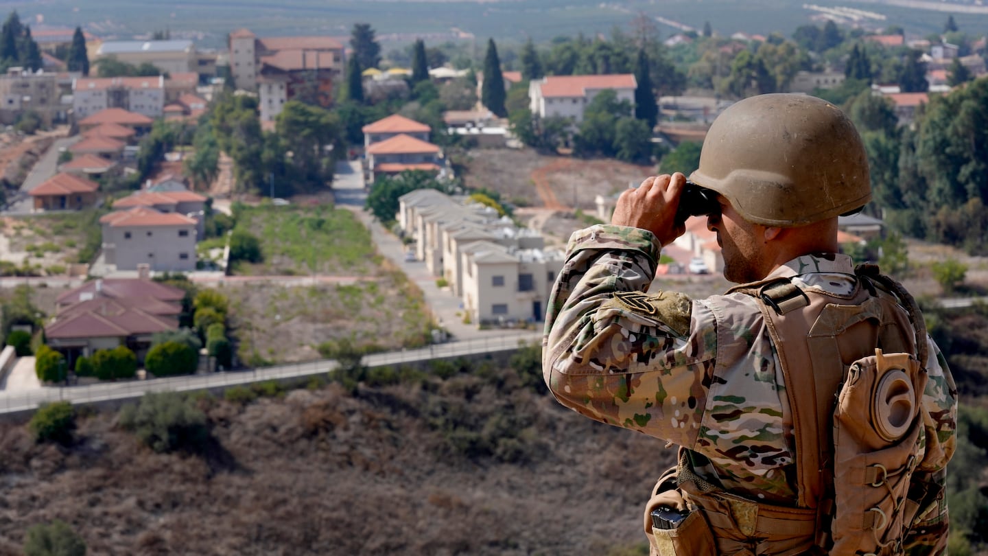 A Lebanese soldier looked through his binoculars into the Israeli town of Metula at the Lebanese side of the border in the southern village of Kfar Kila, Lebanon, last year.