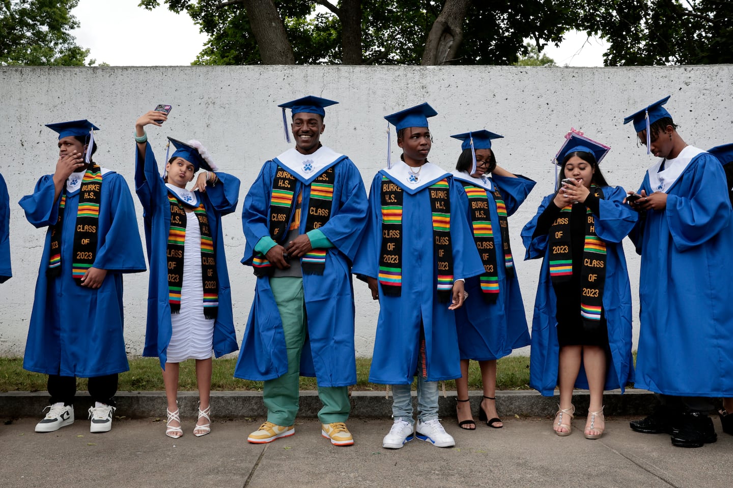 Graduating seniors line up for the procession before the Jeremiah E. Burke High School class of 2023 graduation ceremony at White Stadium in Boston.