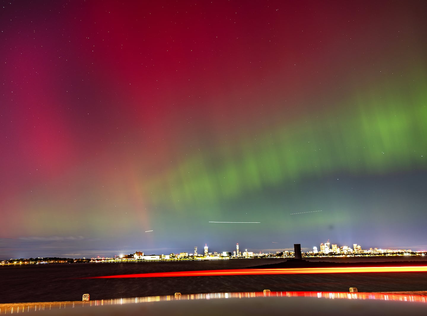 The northern lights were seen over the Boston skyline Thursday night from the Squantum section of Quincy..