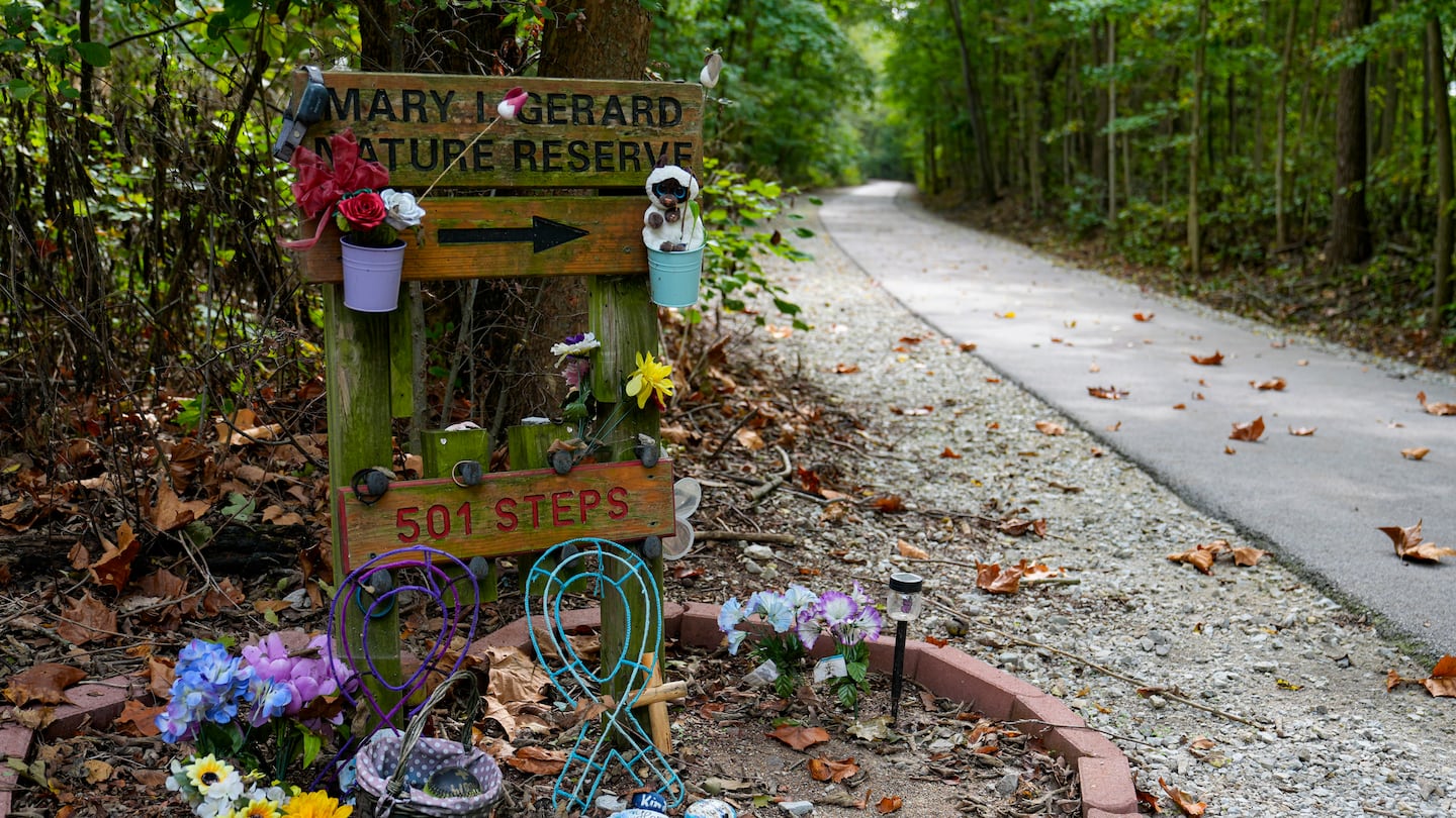 Decorated stones bearing the names of Abigail Williams and Liberty German, who were killed in February 2017, are placed at a memorial along the Monon High Bridge Trail in Delphi, Ind., on Oct. 1.