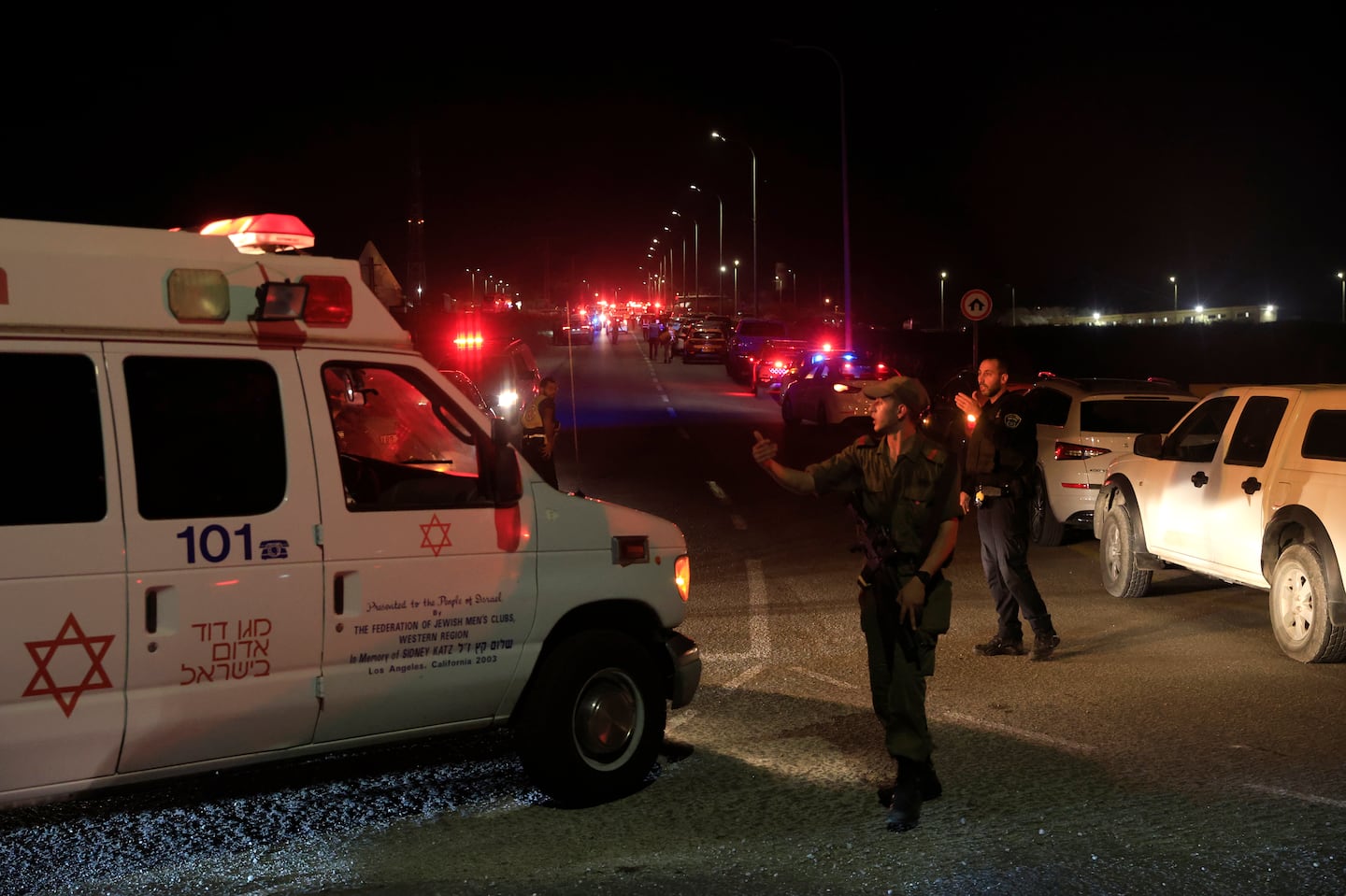 Emergency services personnel attend the scene of a drone strike on Oct. 13 in Binyamina, Israel.