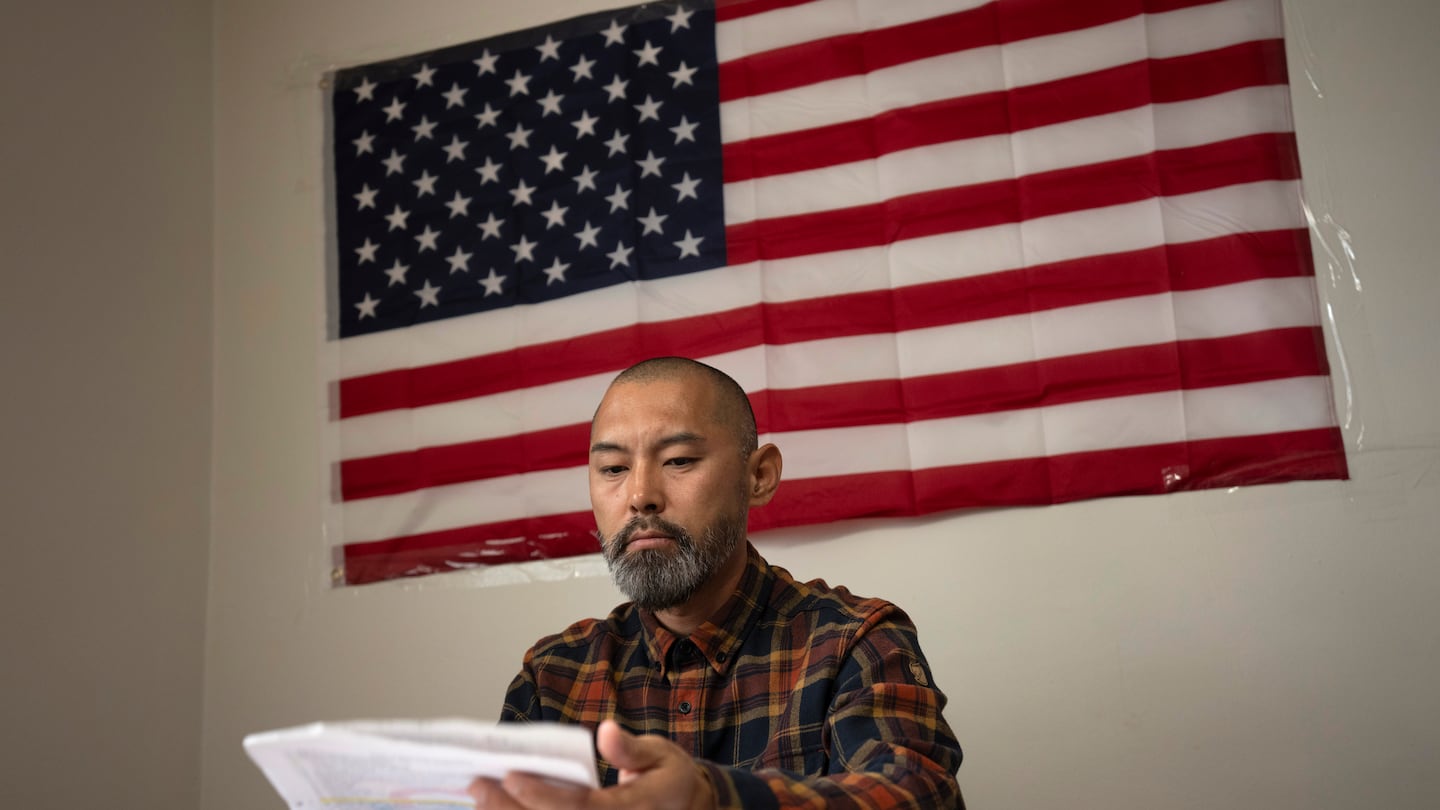 Chinese migrant Li Kai aka Khaled, an ethnic Hui Muslim, studies for a Commercial Driving License in his apartment in Flushing, New York, on May 3. Li Kai came to the US with his wife and two sons seeking religious freedom and a better life.