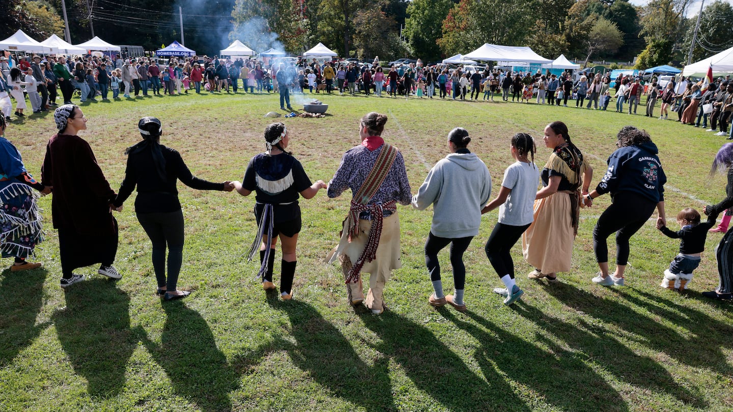 People joined hands during a communal dance at an Indigenous Peoples' Day celebration in Newton in 2023.