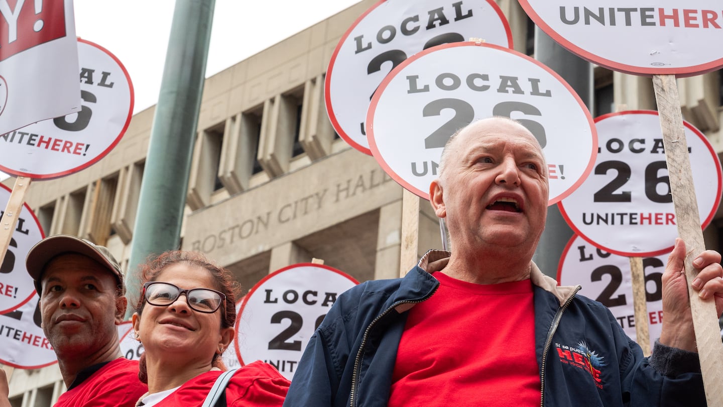 Richie Aliferis (right), who is vice president of UNITE HERE Local 26 and has worked at the Omni Parker House for over 47 years, cheered at a news conference Aug. 8 after a strike authorization vote by the union.