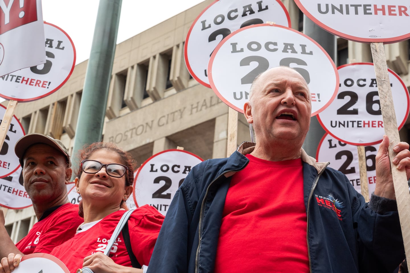 Richie Aliferis (right), who is vice president of UNITE HERE Local 26 and has worked at the Omni Parker House for over 47 years, cheered at a news conference Aug. 8 after a strike authorization vote by the union.