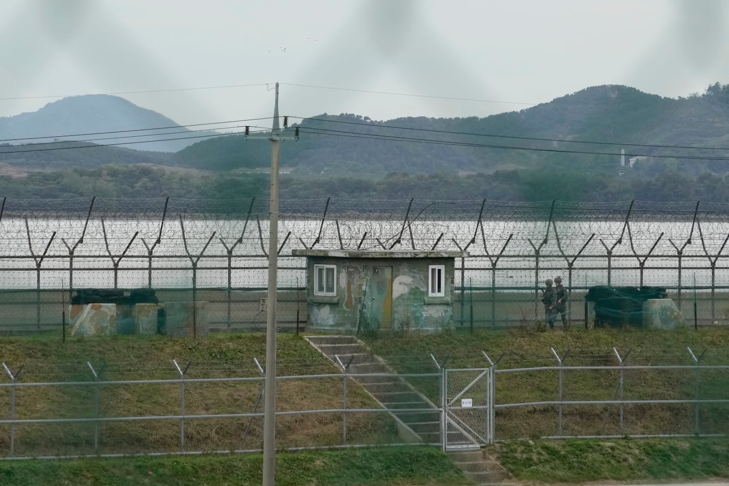 South Korean army soldiers patrol along the barbed-wire fence in Paju, South Korea, near the border with North Korea, on Oct. 14.