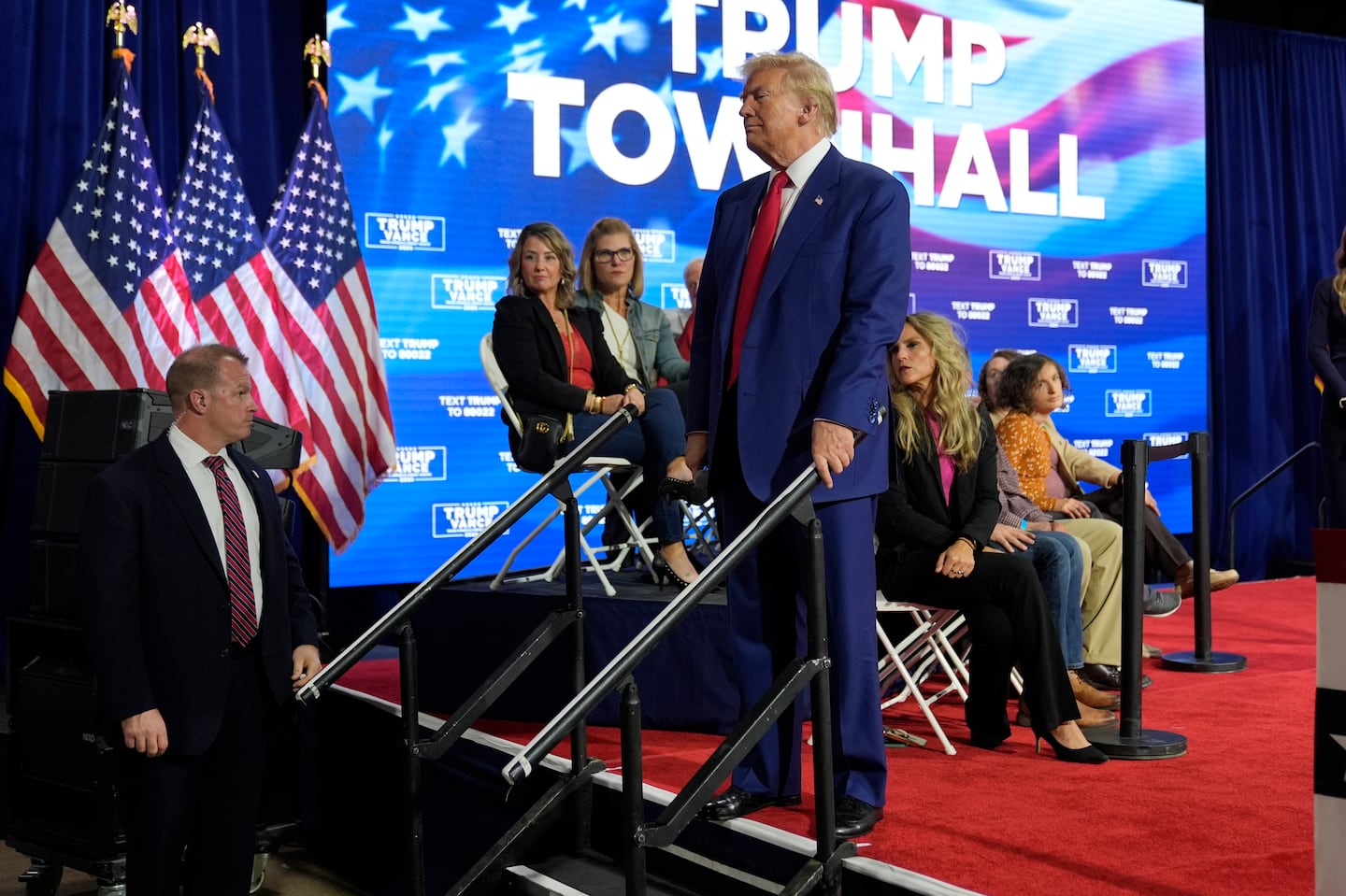 Former president Donald Trump checks on a person having a medical emergency at a campaign town hall at the Greater Philadelphia Expo Center & Fairgrounds, Oct. 14, in Oaks, Pa.