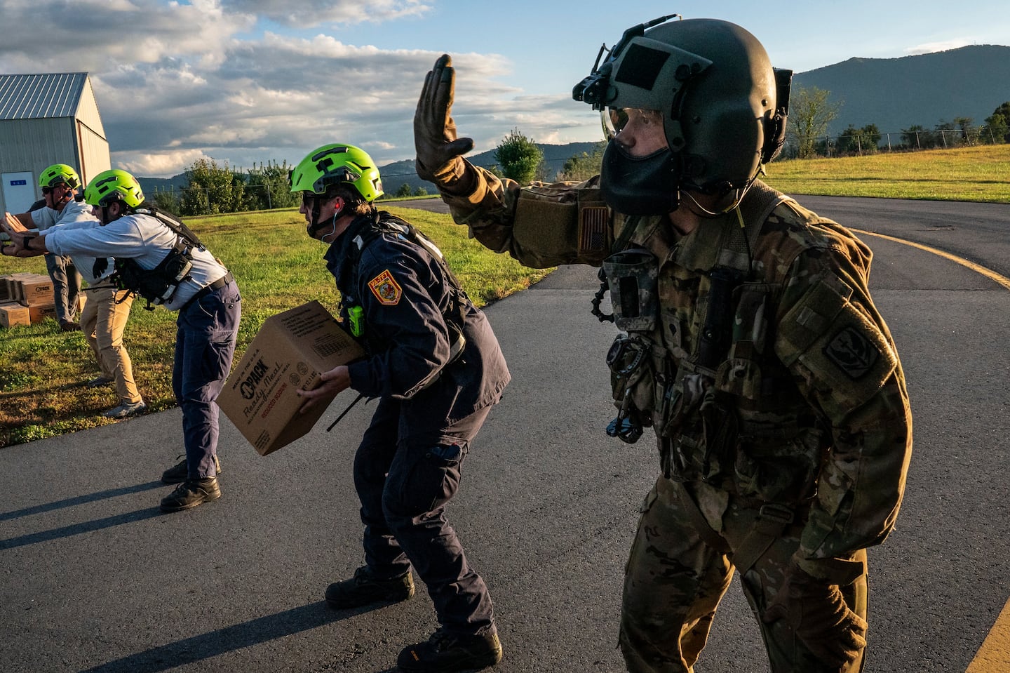 National Guard soldiers, FEMA staff and other aid workers unload food and water from a National Guard helicopter in Jefferson, N.C., on Oct. 2.