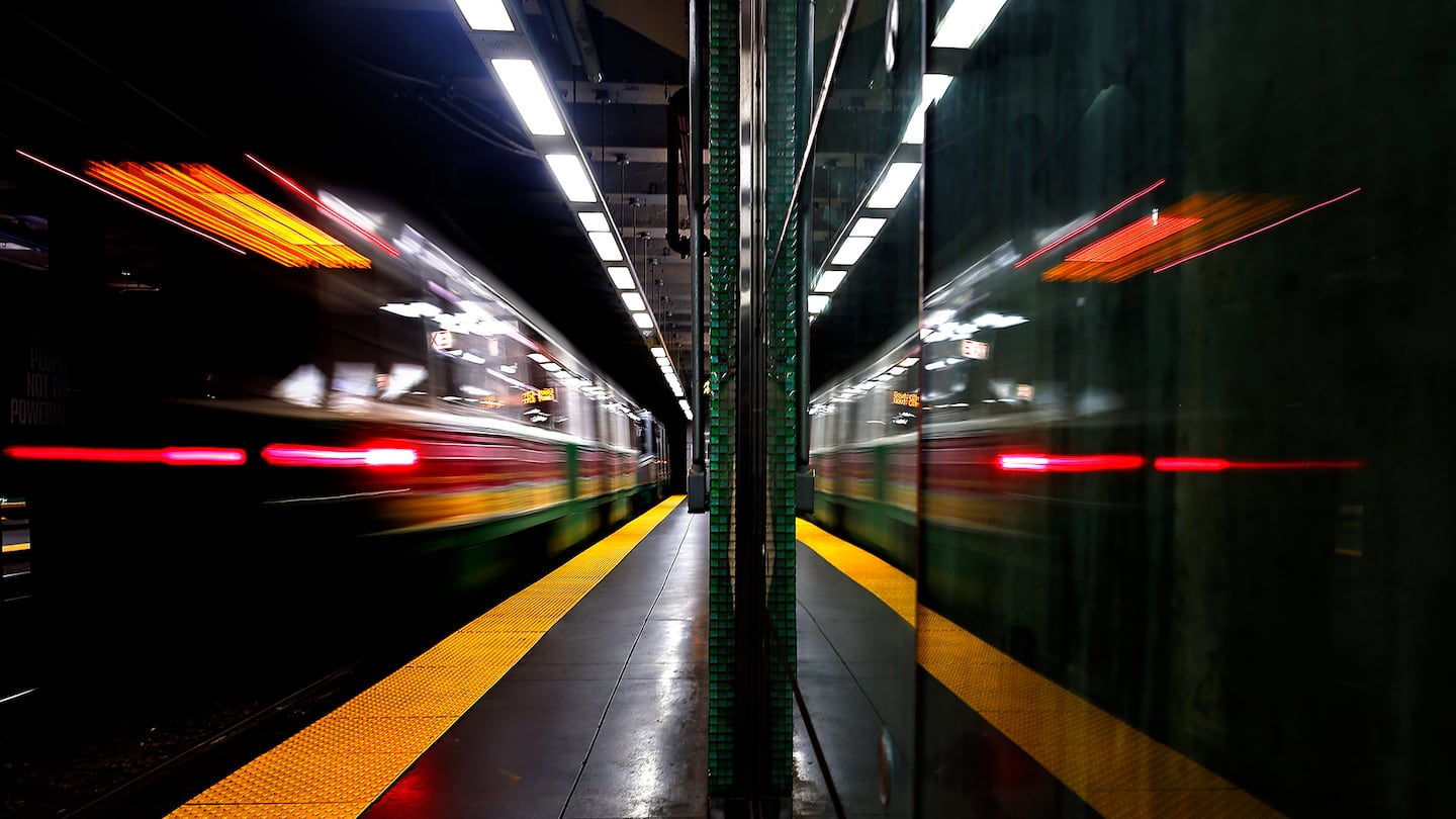 An inbound Green Line train was reflected as it left Kenmore Station.