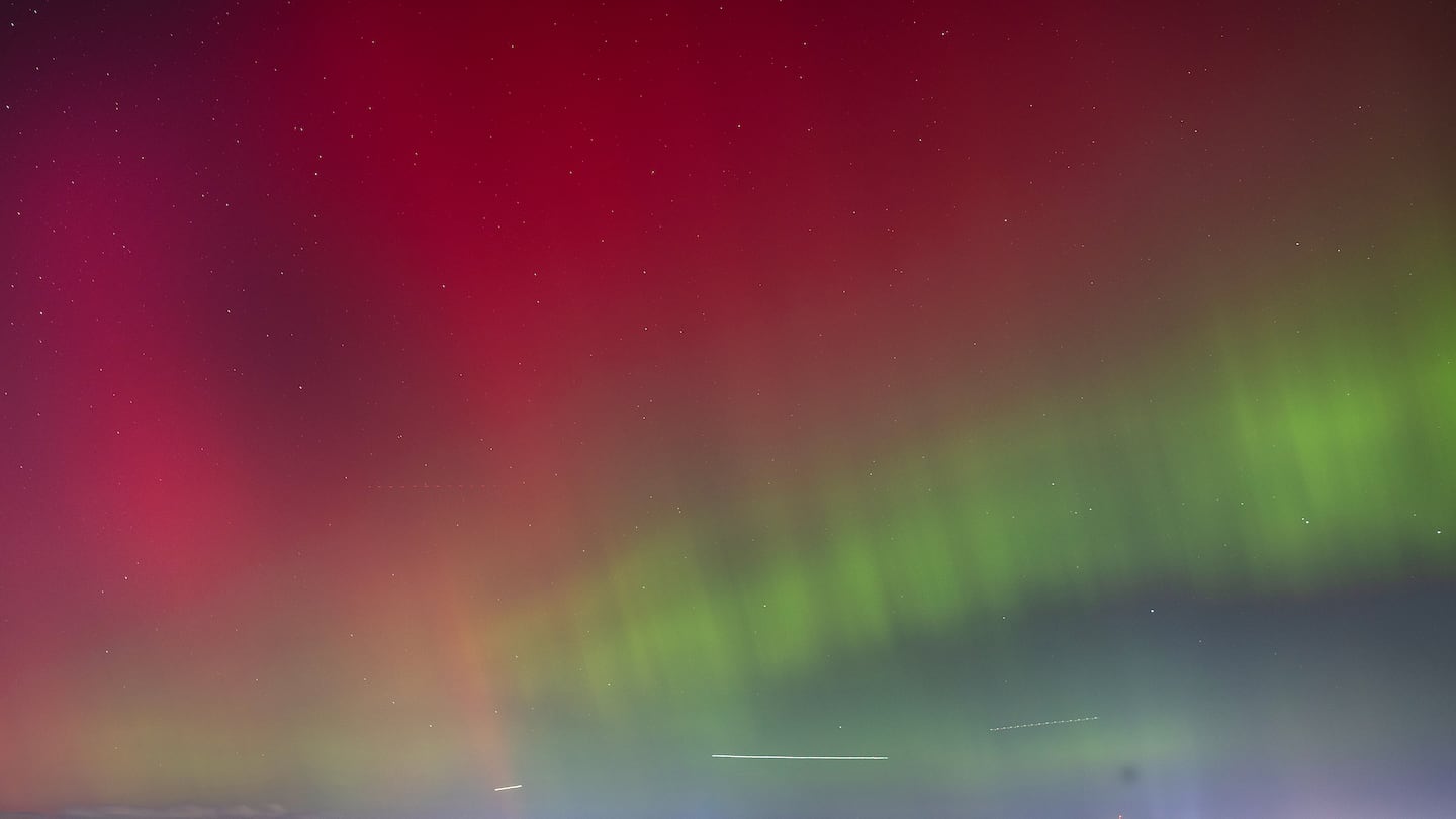 The northern lights were seen over the Boston skyline Thursday night from the Squantum section of Quincy.