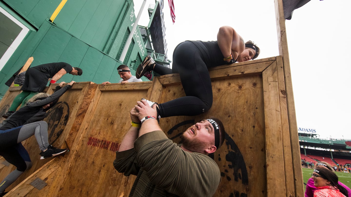 Participants worked together during a Spartan Race at Fenway Park in 2018.