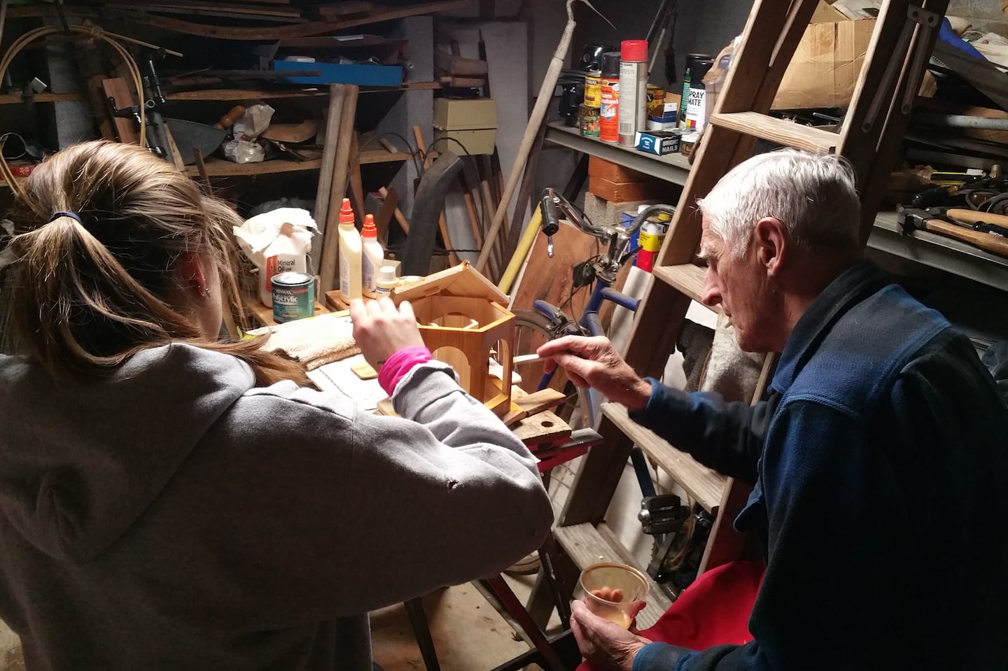 The writer's father, Glenn Selfridge, in the early stages of Alzheimer's, painted bird feeders with his granddaughter, Kate Abraham, in 2014.