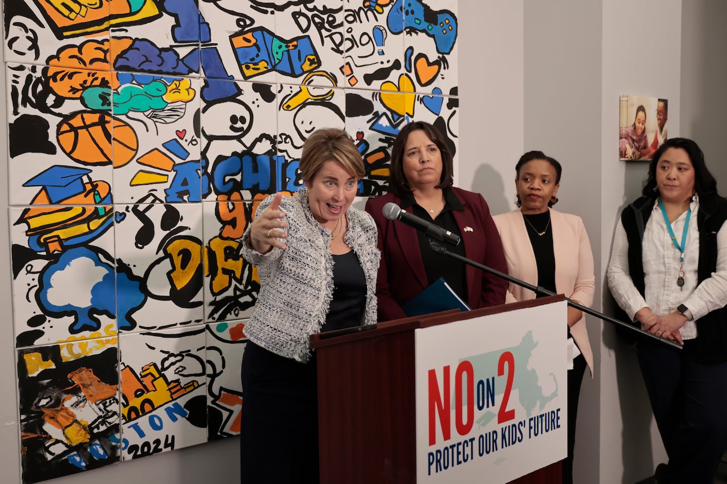 Governor Maura Healey (left) takes questions, as officials hold a press conference detailing their opposition to Question 2, a ballot measure that would eliminate the MCAS as a graduation requirement.  To the right are Lt. Gov. Kim Driscoll , parent and former Cambridge School Committee member Manikka Bowman, and Friends of the Children Executive Director Yi-Chin Chen.