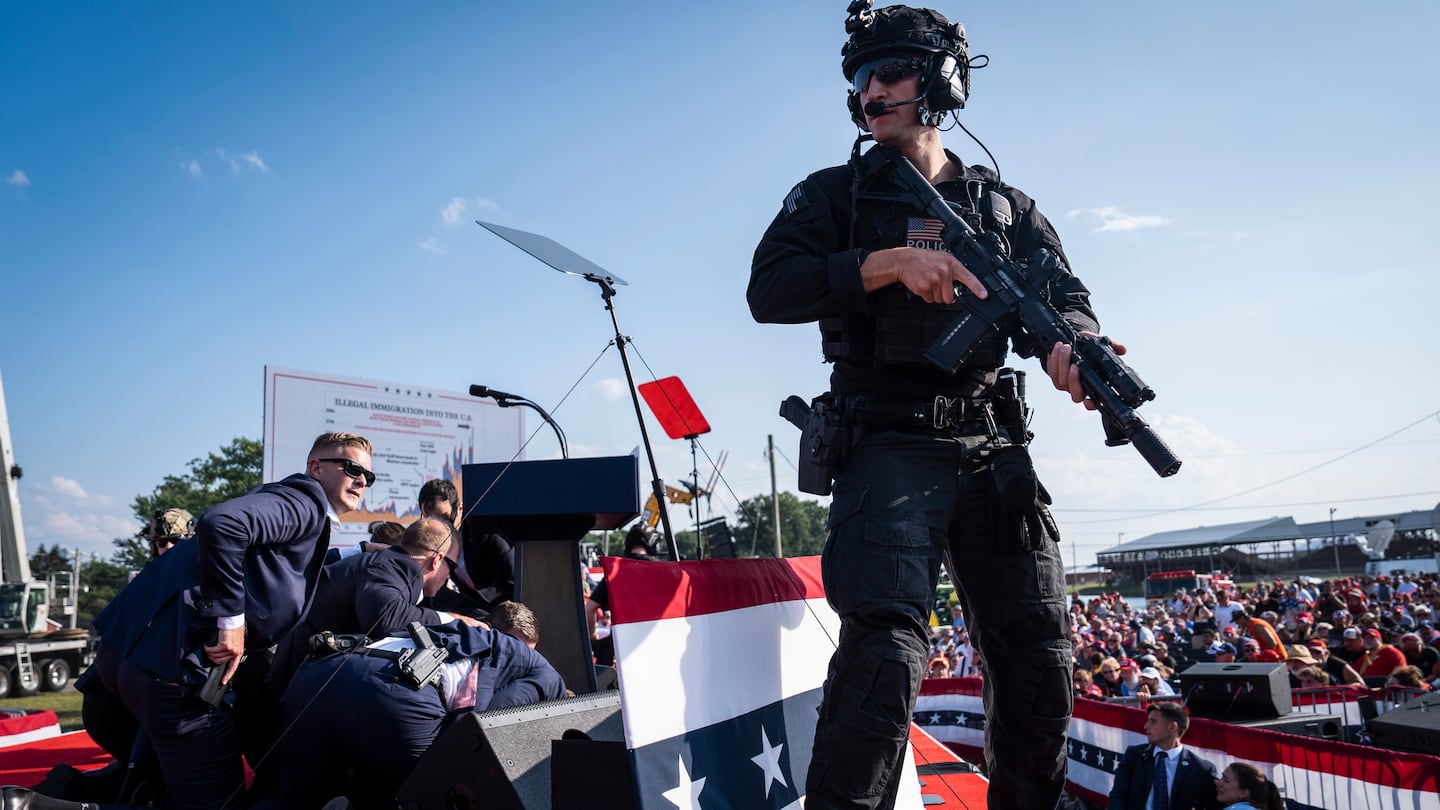 Secret Service agents cover former president Donald Trump after shots were fired during his rally in Butler, Pa., in July.