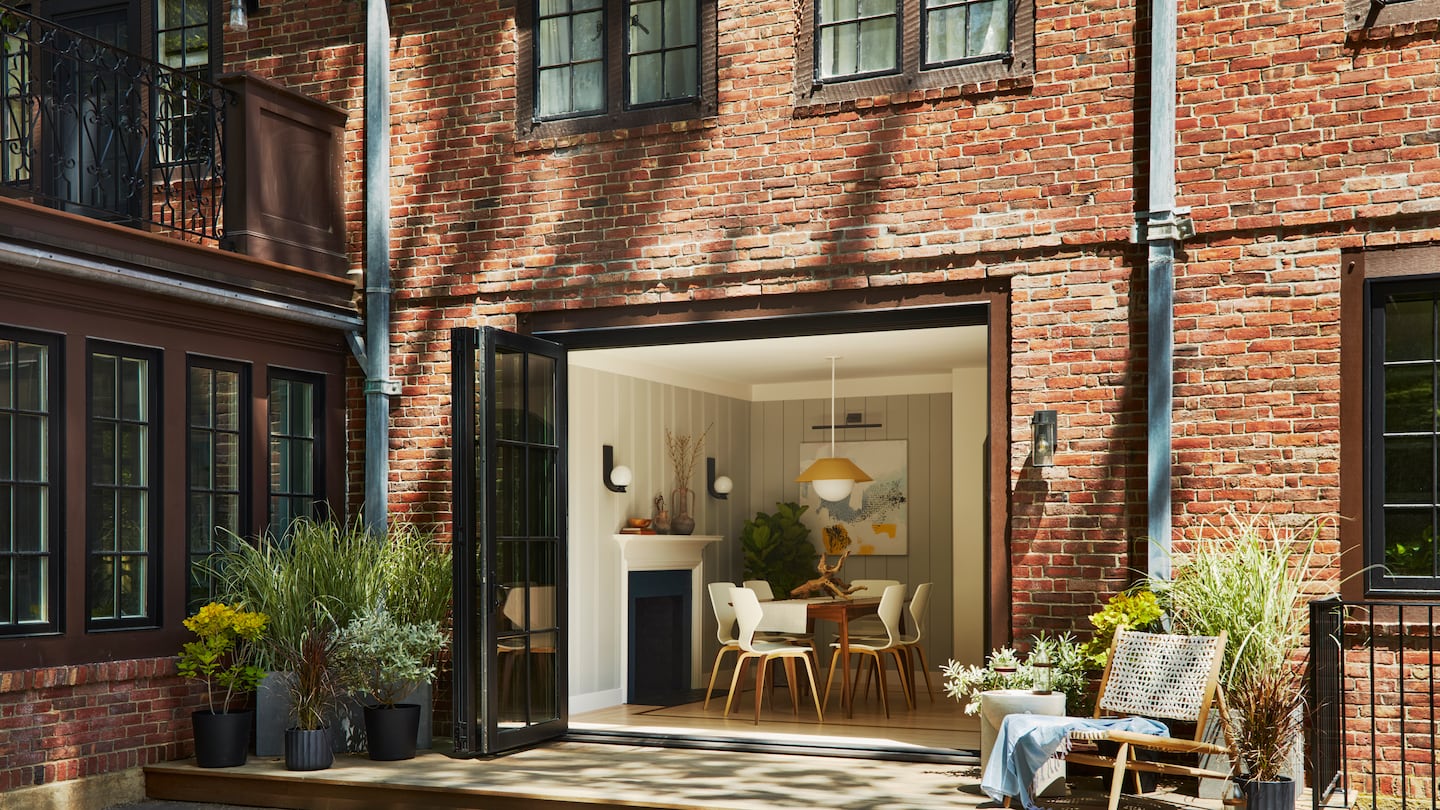 A three-panel door with a retractable screen replaced two windows, opening the reworked rooms to the backyard.