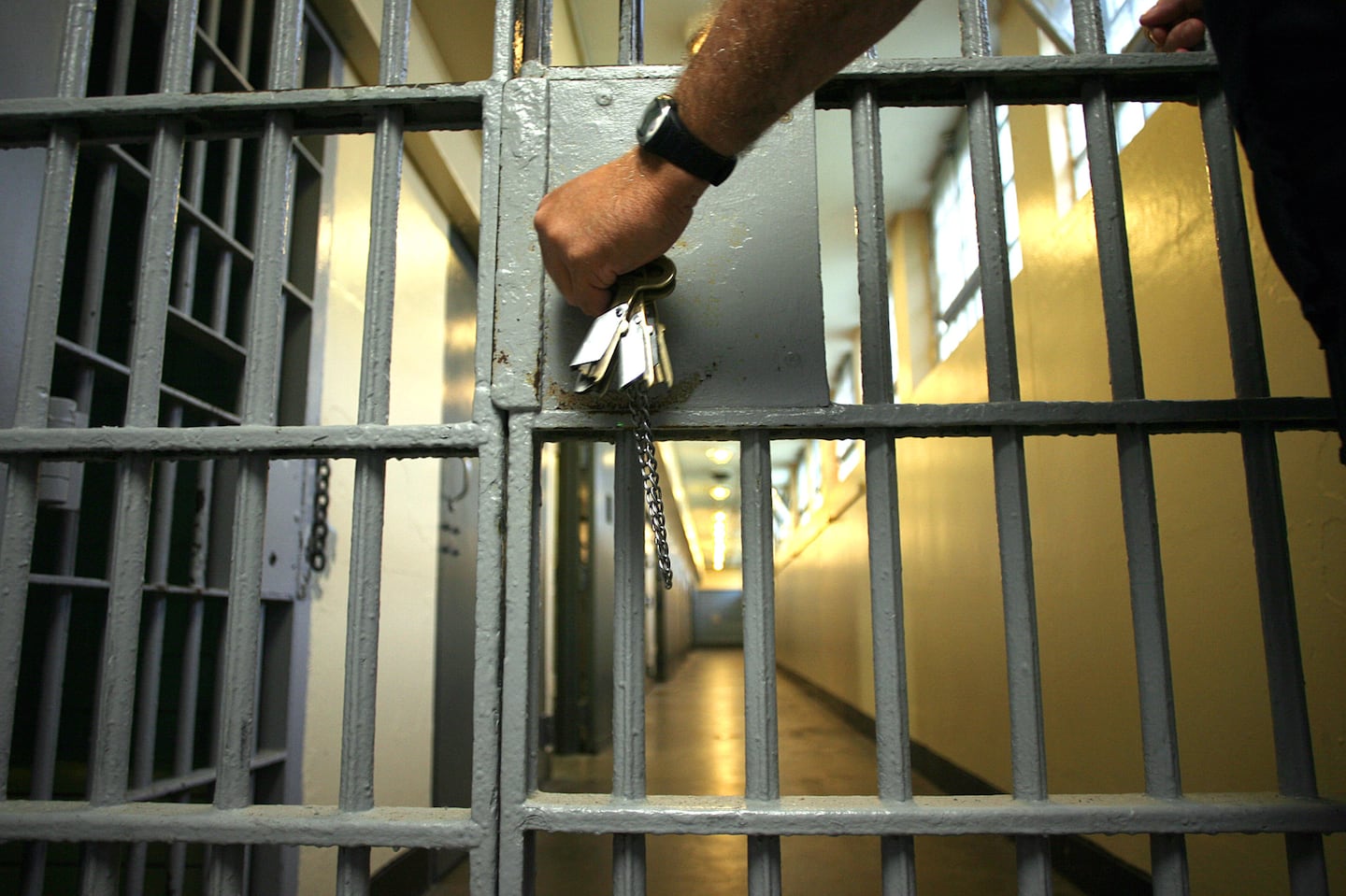 A corrections officer opens the door to one of the wings in a cellblock at MCI Cedar Junction in Walpole.