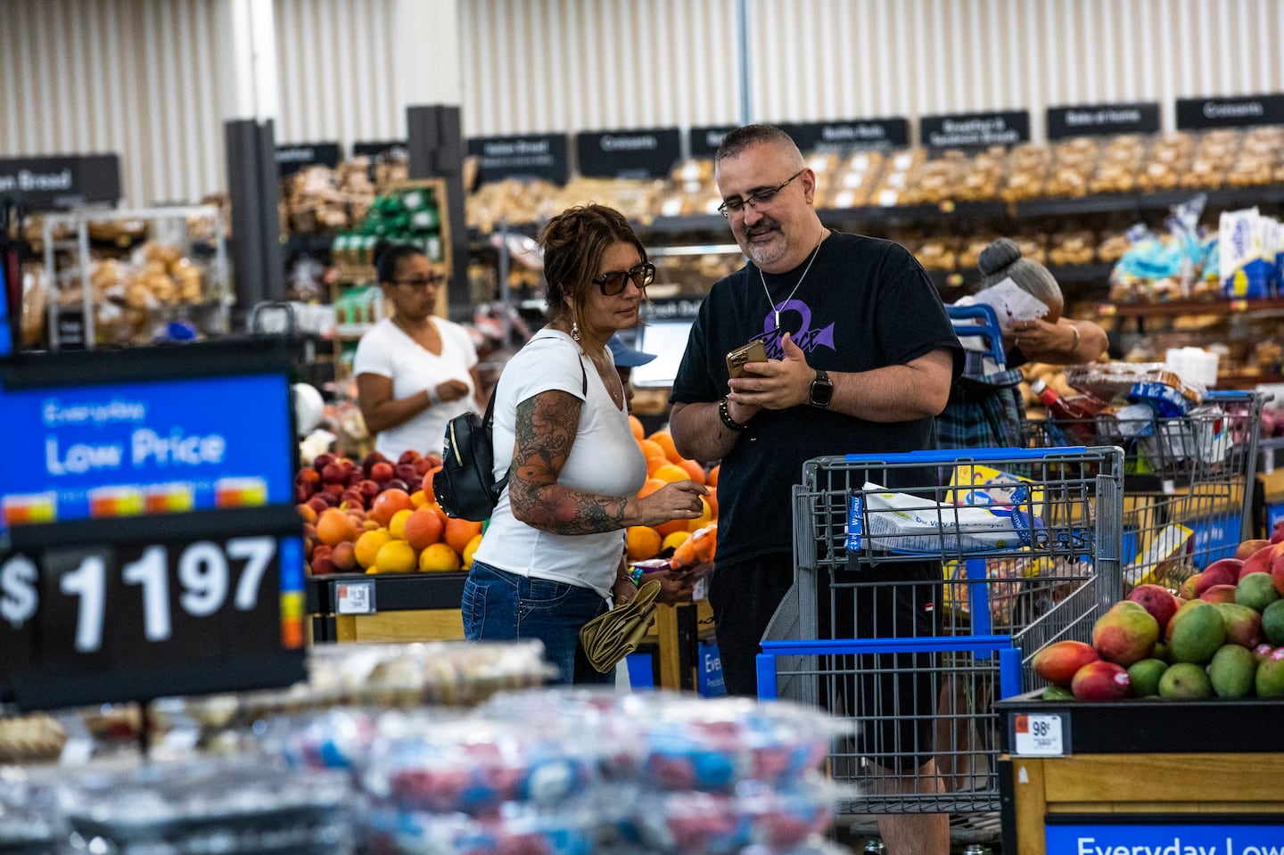 Shoppers paused in the produce section at a Walmart Superstore in Secaucus, N.J., July 11.