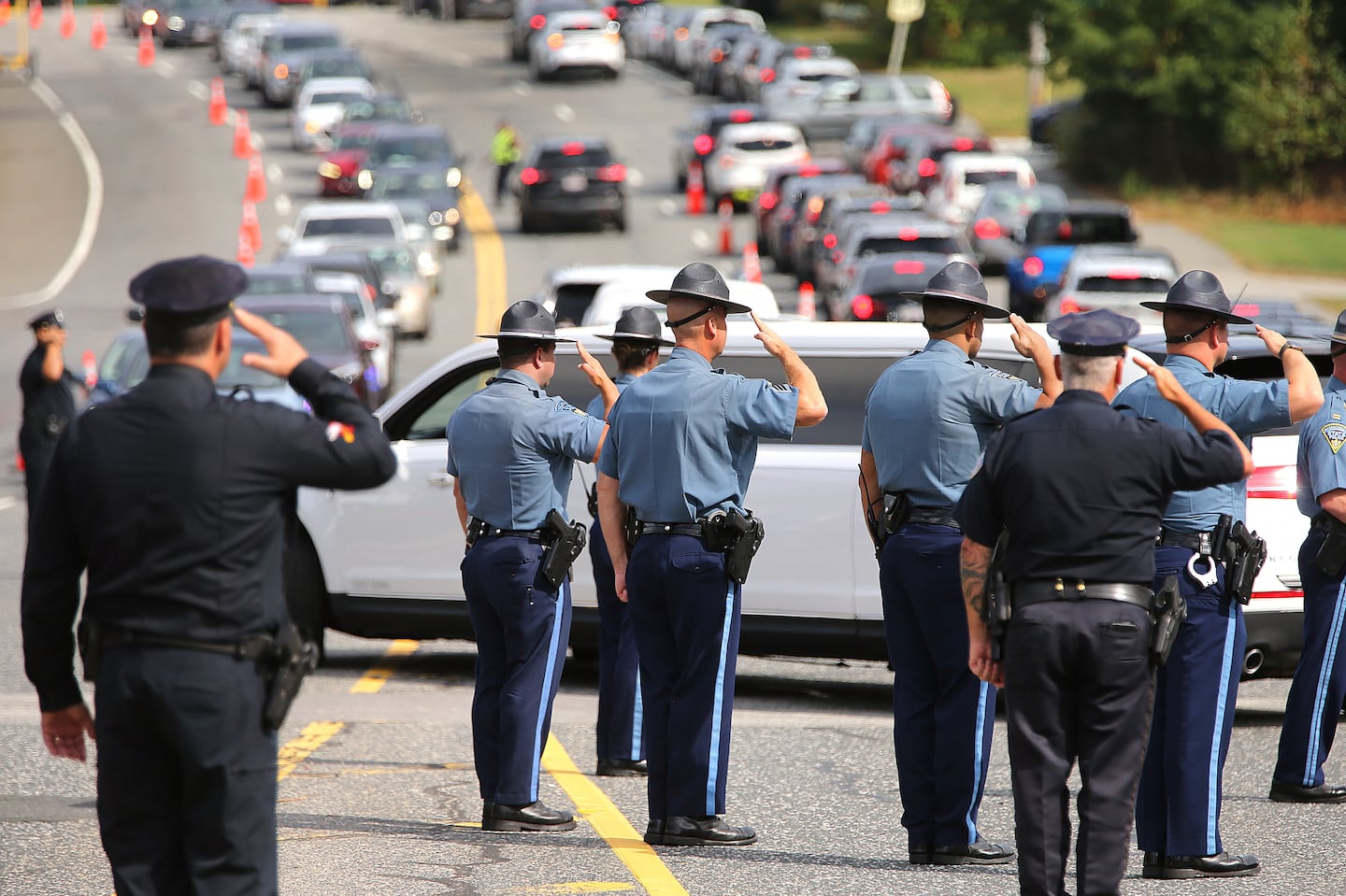 State and Worcester police saluted the motorcade of Massachusetts State Trooper Enrique Delgado-Garcia in Worcester on Sept. 28 at the end of his funeral service.