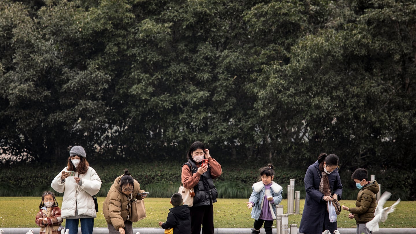 Children and their caretakers at a park in Shanghai, China, in 2023. New incentives encouraging Chinese residents to have children are reigniting a fierce debate about how far the country should go to boost its declining birthrate.