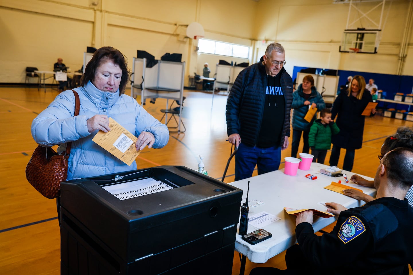 Marie Huether seals her ballot at the BCYF Roche Community Center in West Roxbury in the days leading up to the presidential primaries.