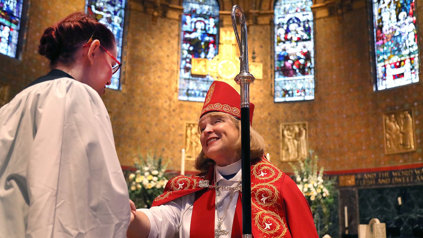 Rev. Julia Whitworth greets well-wishers at after her ordination. She became the first woman to head the Diocese of Massachusetts.