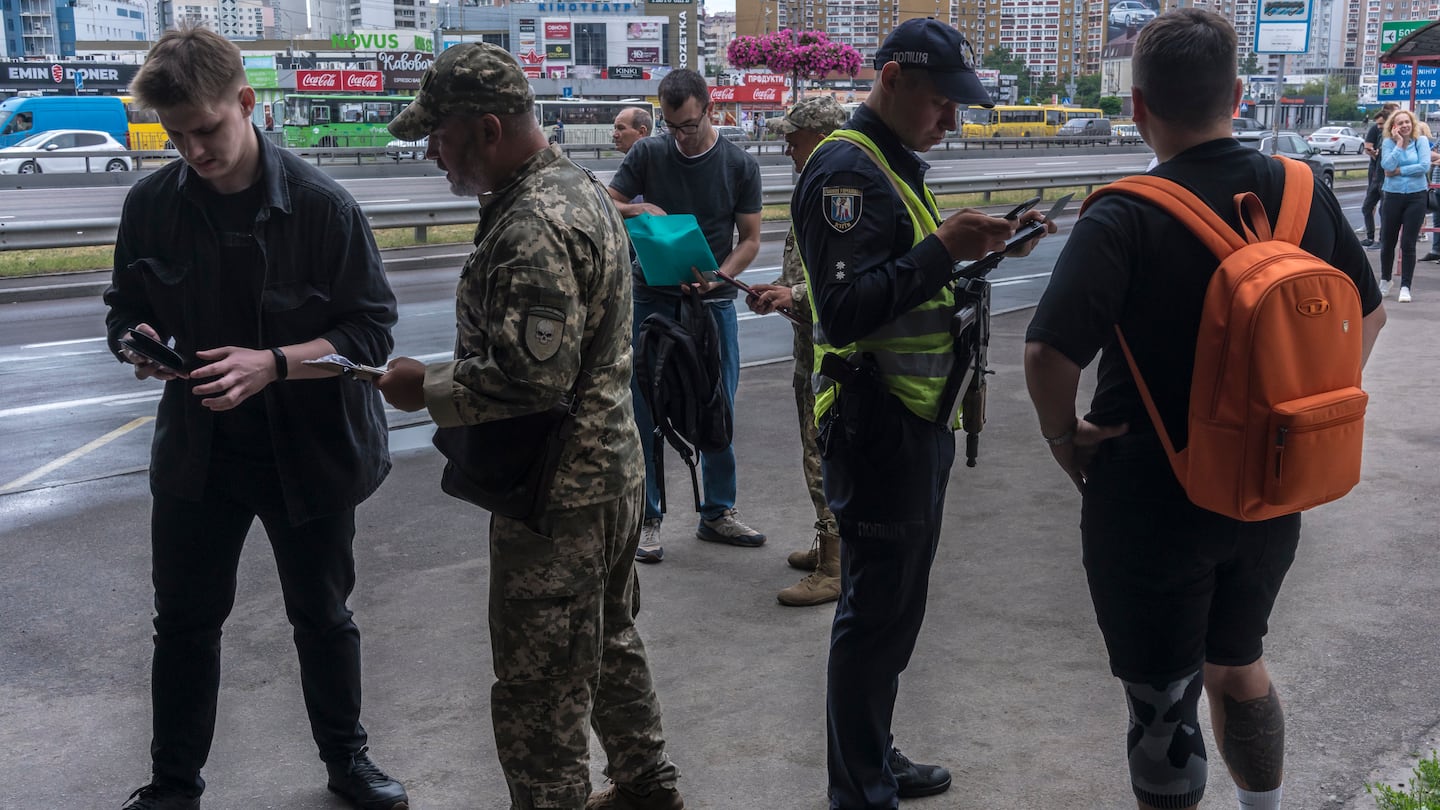 Ukrainian military officials stop men on the streets of Kyiv to check whether they have updated their information with the draft office, on June 11, 2024. Serhii Hnezdilov, a Ukrainian soldier, said he wanted to draw attention to the need to discharge worn-out soldiers and replace them with fresh conscripts.