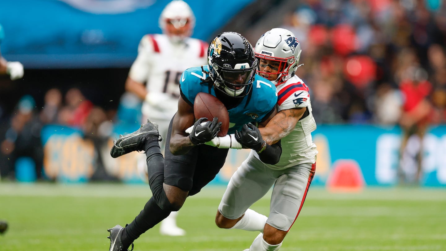 Patriots cornerback Christian Gonzalez (right) brought down Jaguars wide receiver Brian Thomas Jr. in the second quarter.